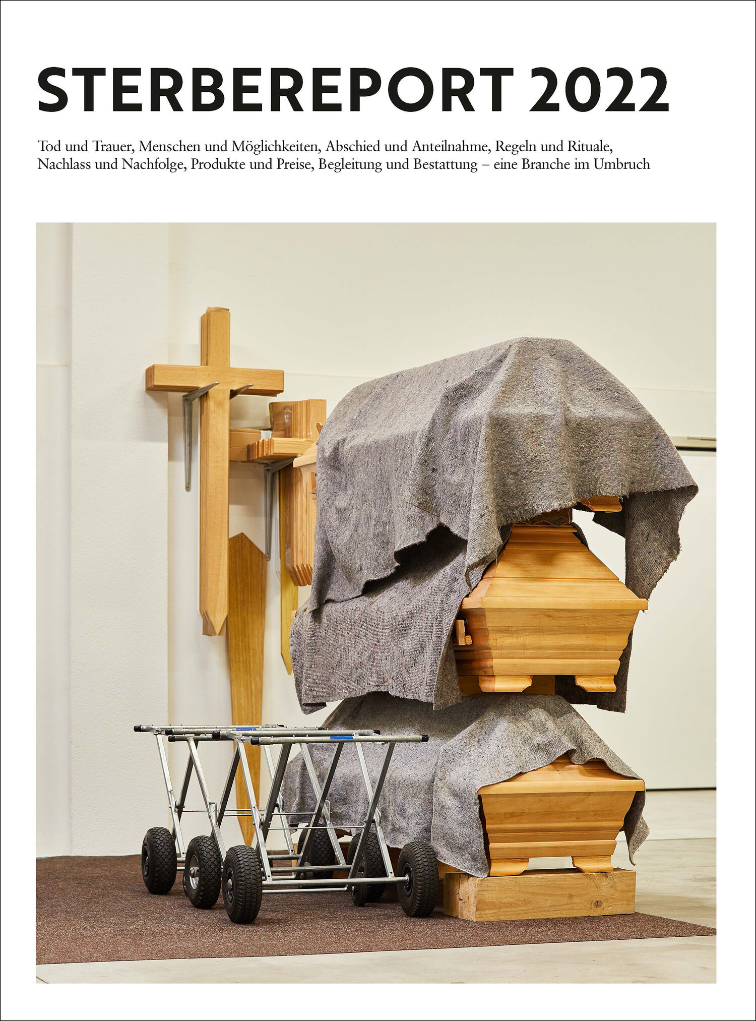 Cover page of the “Sterbereport 2022” with a photo of coffins and wooden crosses, visually representing the themes of death and burial.